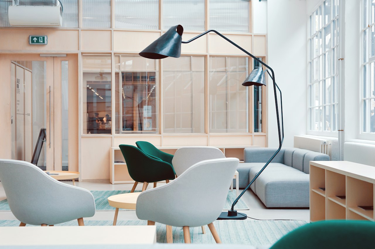 Bright modern office reception area with lounge seating and large windows
